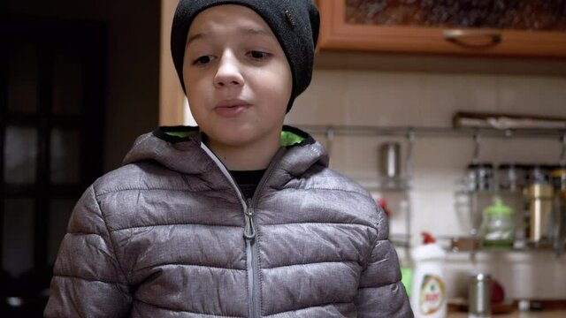 Boy in Jacket Feels Guilty and Ashamed, He Looks Down and Starts Making Excuses