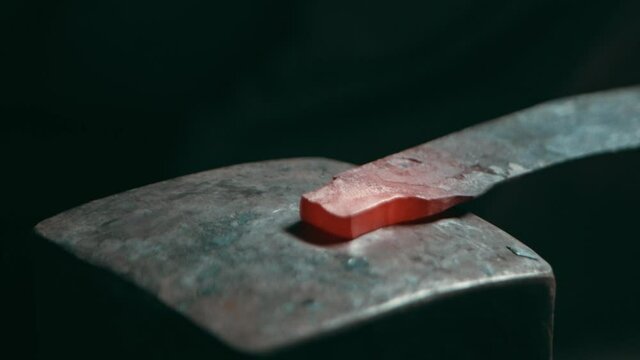 Metal knife handle end piece hammered on a square anvil