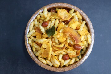 Murmura cornflakes Chivda or Chiwada. Diwali special savory snack mixture, made out of puffed rice, fried peanuts, curry leaves, and some spices. Traditional Indian Diwali Snacks. with Copy Space.