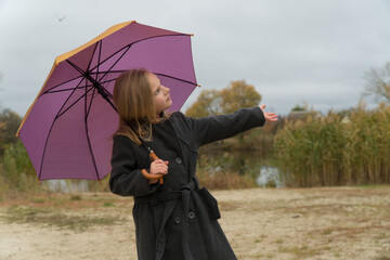 
girl with umbrella standing in the rain