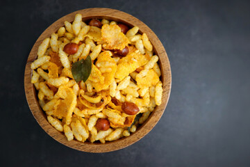 Murmura cornflakes Chivda or Chiwada. Diwali special savory snack mixture, made out of puffed rice, fried peanuts, curry leaves, and some spices. Traditional Indian Diwali Snacks. with Copy Space.