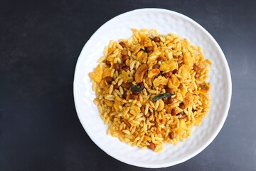 Murmura cornflakes Chivda or Chiwada. Diwali special savory snack mixture, made out of puffed rice, fried peanuts, curry leaves, and some spices. Traditional Indian Diwali Snacks. with Copy Space.