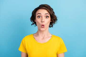 Obraz na płótnie Canvas Photo of surprised cute lady shocked face look camera wear yellow t-shirt isolated blue color background