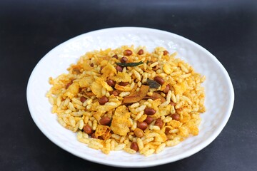 Obraz na płótnie Canvas Murmura cornflakes Chivda or Chiwada. Diwali special savory snack mixture, made out of puffed rice, fried peanuts, curry leaves, and some spices. Traditional Indian Diwali Snacks. with Copy Space.