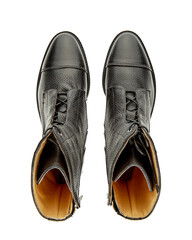 Beautiful autumn leather boots with a high top with laces and a massive sole with a low heel, isolated on a white background with a shadow. Top view.