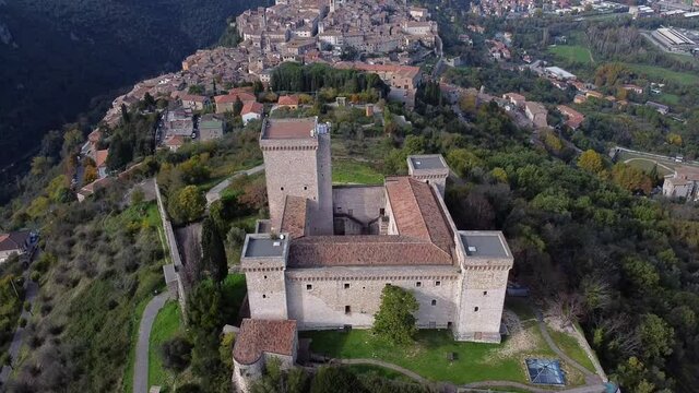 Aerial view of Narni in Umbria in central Italy with castle rocca Albornoziana in the foreground and the city in the background. reveal with backward move and tilt up.