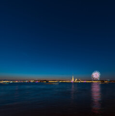 Panorama of the Peter and Paul Fortress in Saint Petersburg, Russia, with the Neva river in the foreground, by night with fireworks behind the fortress and ample space for text in the deep blue sky