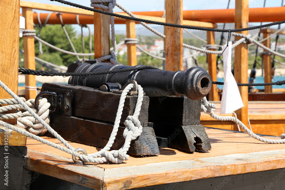 Sticker Old medieval cannon on the deck of a ship