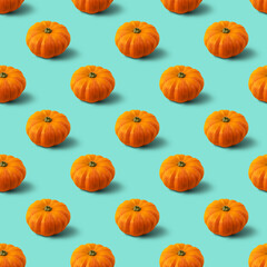 Seamless pattern with pumpkin on mint background. Autumn abstract background. Minimal vegetable concept.