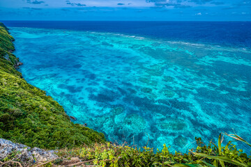 Fototapeta na wymiar The Sankakuten landmark on Irabu Island, where a tropical reef meets the coastline cliffs. Miyakojima, Okinawa, Japan