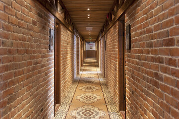 A hotel corridor with a vintage runner carpet 