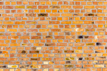 Old wall of cracked yellow bricks, background