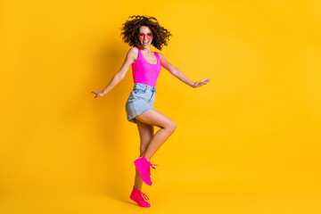 Fototapeta na wymiar Full length body size view of her she nice attractive cheerful cheery wavy-haired girl jumping having fun dancing free time entertainment isolated on bright vivid shine vibrant yellow color background