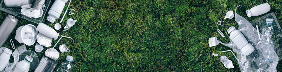 Plastic waste, food packaging, trash collection on green moss background after picnic in forest. Plastic free. Top view. Copy space. Recycling plastic. Environmental pollution, ecology concept. Banner