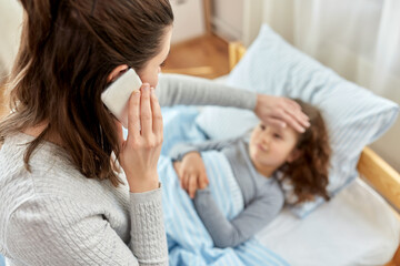 family, health and people concept - ill daughter and mother with smartphone calling doctor at home