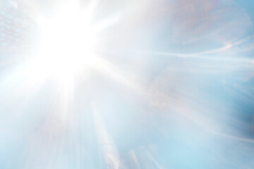 Blue blurred background with sun rays.