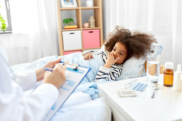 healthcare, medicine and people concept - doctor with clipboard talking to coughing little sick african american girl lying in bed at home