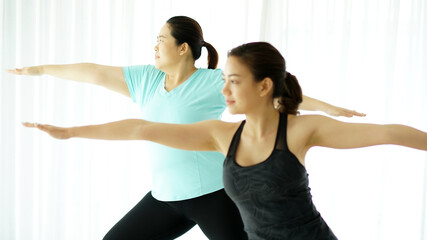 Fototapeta na wymiar Two woman practicing yoga together