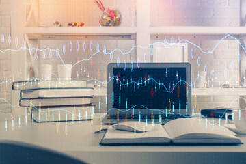 Financial chart drawing and table with computer on background. Multi exposure. Concept of...