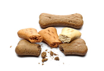 Dog food, cracked and broken pet treats in bone shape isolated on white background