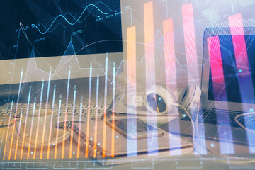 Financial chart drawing and table with computer on background. Double exposure. Concept of...