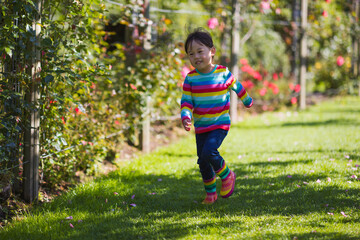 young girl running in the summer garden in the morning