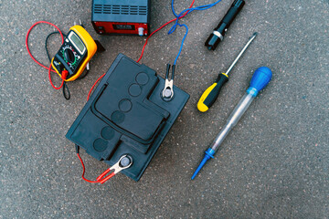 Top view of the battery and tools for diagnosing and repairing the battery.