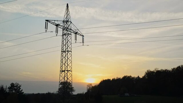 Transmission tower during sunset. Silhouette of a transmission towers during sunset. Silhouette of power lines during sunset.