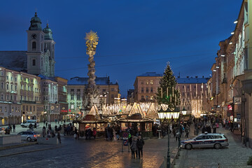 Linz, Austria. The city's main Christmas market at the baroque Hauptplatz (Main Square) in dusk.