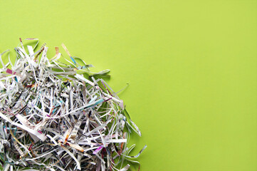 Shredded paper on light green background.