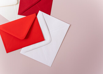 red and white envelopes on pink background