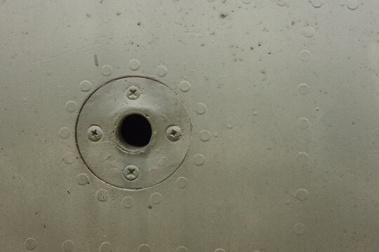 Detail of an old camouflage surface with exfoliated paint on a military aircraft. Fragment of a fuselage of an old jet fighter