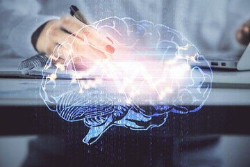 Multi exposure of woman's writing hand on background with brain hologram. Concept of brainstorming.