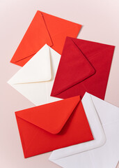 red and white envelopes on pink background