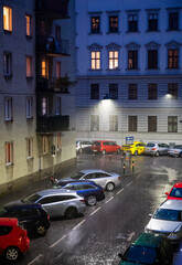 Colourful cars in a rainy street at night