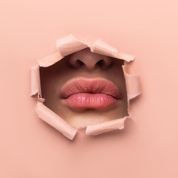 Beautiful girl plump young lips on a beige background close-up. Cosmetology injection augmentation concept. Plastic increase in lip volume. Care cosmetics balm. Copy space banner  place for text 