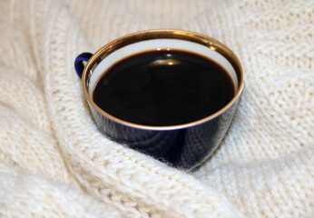 knitted blanket and a cup of coffee
