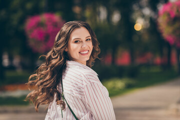 Rear behind view portrait of adorable brunette woman walk city central park active way life wear...