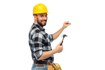 profession, construction and building - happy smiling male worker or builder in helmet with hammer and nail over white background