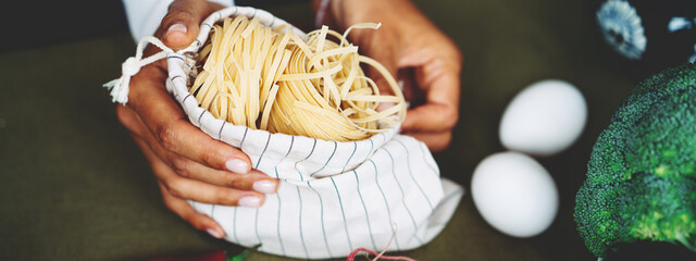 Spaghetti with woman's hands on the table with delicious food