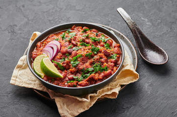 Rajma Masala Curry in black bowl on dark slate table top. Red Kidney Bean Dal is indian cuisine vegetarian dish. Asian food, meal