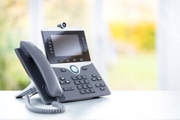 Business voip telephone with liquid crystal display on a desk in an office