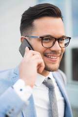 Happy successful manager having business call