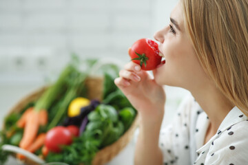 Beautiful young woman eating vegetables in the kitchen. Healthy food. Vegan salad. Diet. Diet concept. Healthy lifestyle. Cook at home. High quality photo.