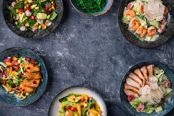 Asian salads with copy space in center. Menu, cuisine, kitchen concept
