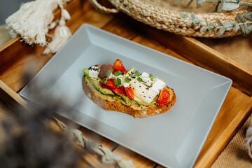 Healthy vegetarian food for a balanced diet rich in vitamins. Organic and regional products. Bread, tomatoes, avocado