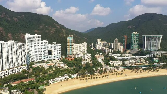 Aerial footage of the famous Repulse Bay beach and residential tower in the south of Hong Kong island on sunny day in Hongkong SAR, China