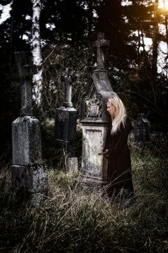 A woman who mourns in a cemetery