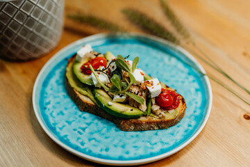 Healthy vegetarian food for a balanced diet rich in vitamins. Organic and regional products. Bread, tomatoes, avocado