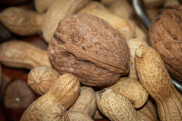 Close-up view of a bowl of peanuts, walnuts and hazelnuts